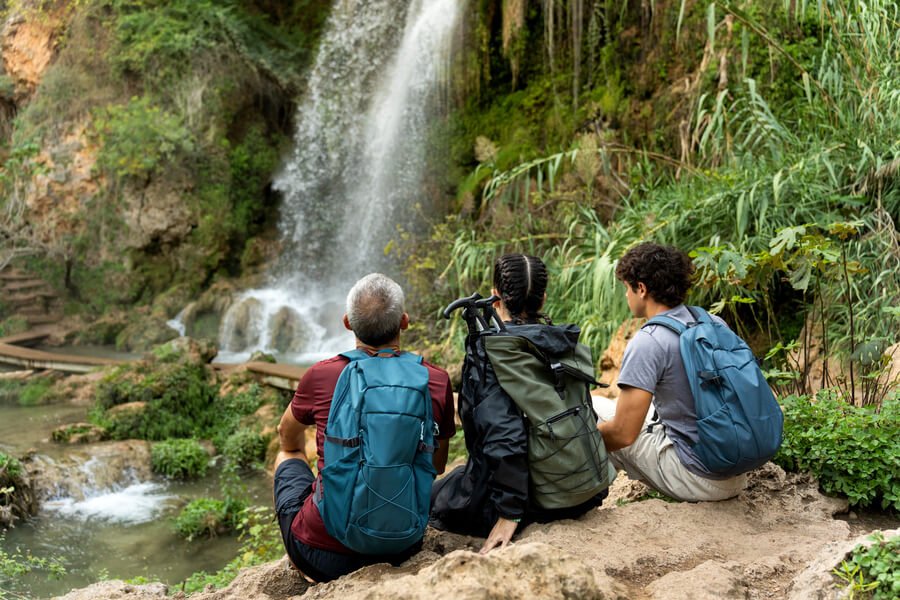 Travelers enjoying a waterfall in Guatemala