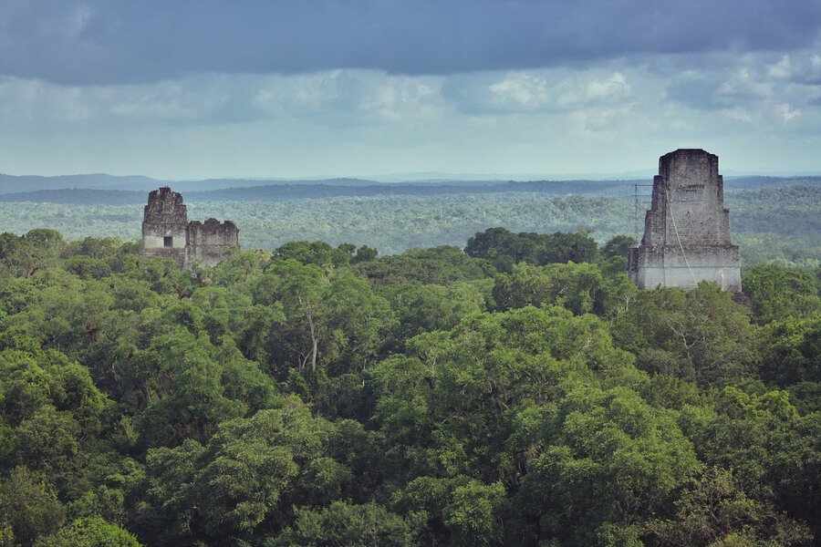 Ancient Tikal pyramids rising above the rainforest
