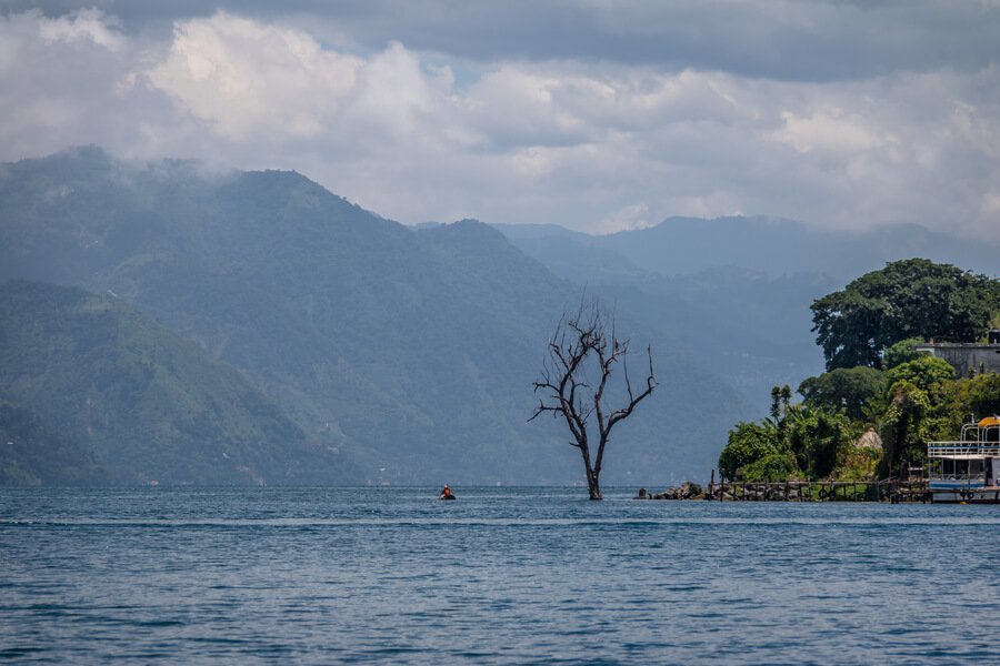 Lake Atitlán with mountains and the famous lone tree