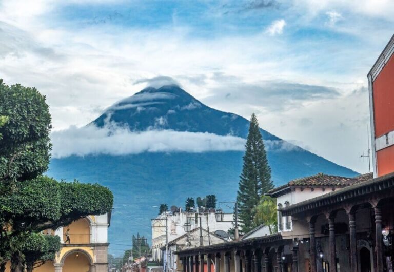 Antigua guatemala what to see - Scenic view of Antigua Guatemala with volcano, colonial architecture, and church steeple.